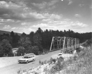Car With a Canoe on Top Driving Across Abol Bridge