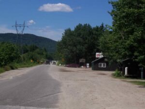 Abol Store with Trucks Driving Across Abol Bridge