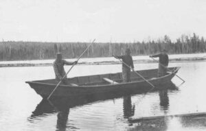 Three Men Rowing a Boat at Seboomook