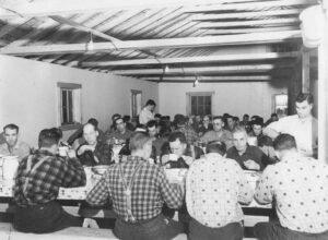 Big Crew Eating Dinner at an Old Camp