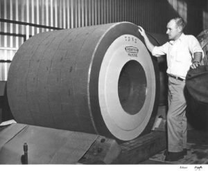 Man Inspecting a Grinder Stone in the East Millinocket Mill