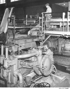 Man Watching the Grinders Feeding in the East Millinocket Mill