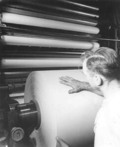 Man Looking at a Paper Roll in the East Millinocket Mill