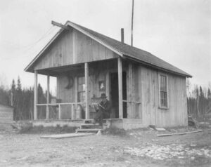 End Heron Lake Building with a Man Sitting on the Steps Reading