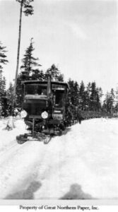 Lombard Tractor Hauling a Log Train Over the Road