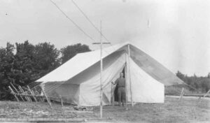 Man Standing in Front of a Tent