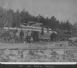 Men Standing in Front of an Old Boom House