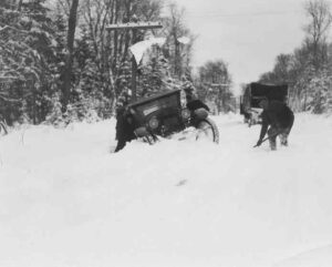 Old Car Stuck off the Side of the Road during Winter in the 1920's in Millinocket, Maine