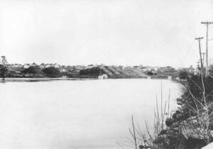Piles of Long Logs on the Lake Near Millinocket