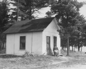 Rice Farm Cancas Shack with Woman Sitting in the Front