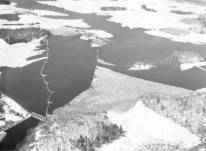 Arial View of Stone Dam and Quakish Lake Full of Wood