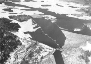 Arial View of Stone Dam and Quakish Lake Full of Wood