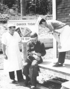 Two Cooks and a Forester Holding a Pet Fox