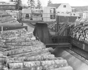 Unloading Wood with a Gradeall