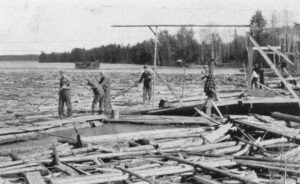 Five Men Poling Wood